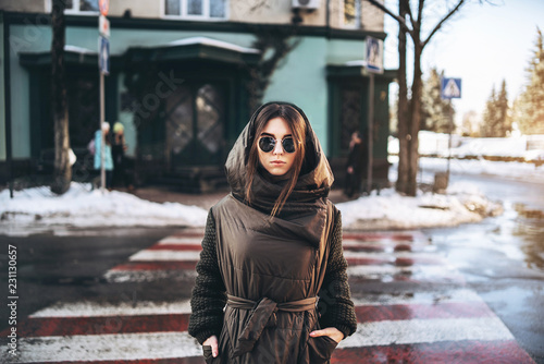 Pretty girl walking oon the street, winter time.