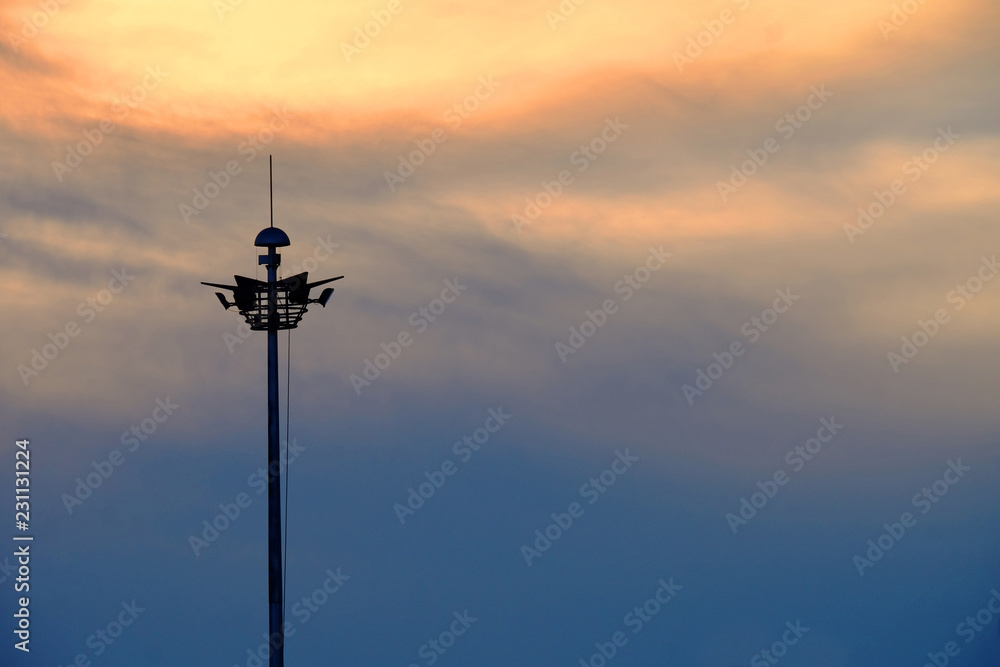 Silhouette of sphere lamp pole over the sun during sunset in landscape orientation