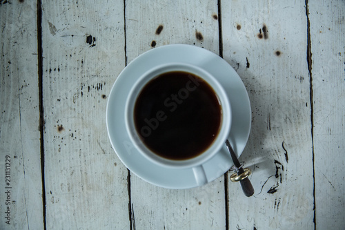 cup of coffee on wooden table with ring