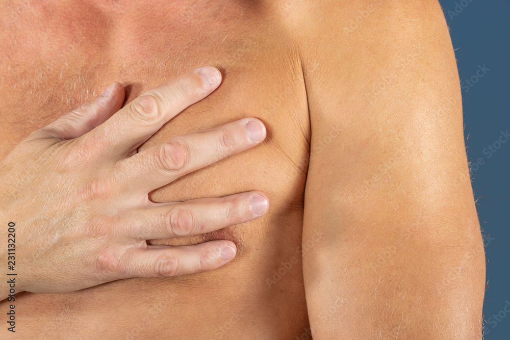 Man suffering from chest pain, having heart attack or painful cramps, pressing on chest with painful expression on blue backgound. Severe heartache Man suffering from chest pain, having heart attack or painful cramps, pressing on chest with painful expression on blue backgound. Severe heartache