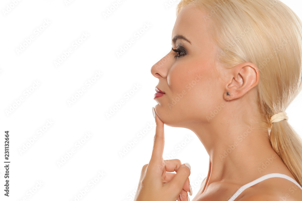 Portrait of beautiful blonde woman touching her chin on white background Portrait of beautiful blonde woman touching her chin on white background