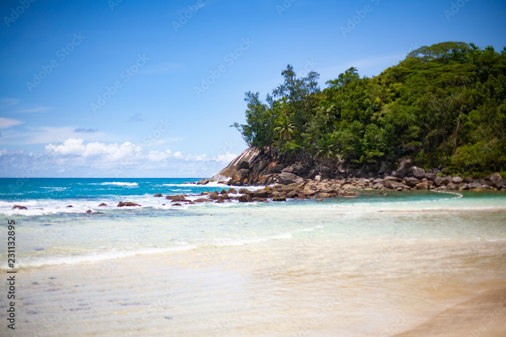 Fototapeta premium Landscape photo of beautiful white sand exotic beach on Mahe island in Seychelles