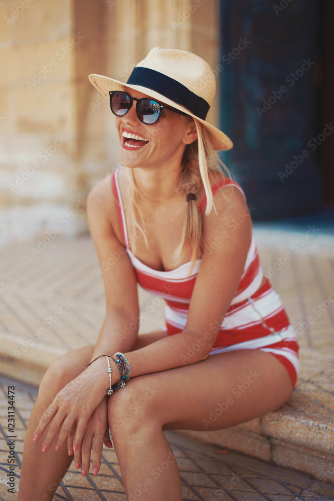 Happy young mediterranean woman laughing on steps Happy young mediterranean woman laughing on steps