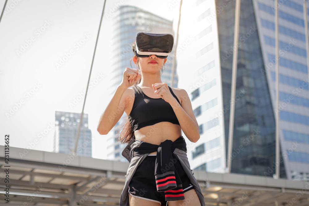 Asian fitness woman with VR glasses and doing exercise at outdoor, city sport woman concept