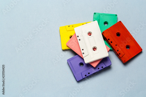 Bright retro cassette tapes on a light grey background