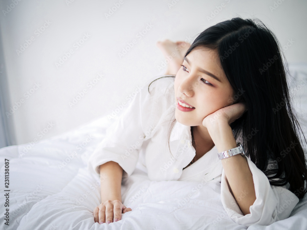 Happy Asian woman relaxing on bed, lifestyle concept. Happy Asian woman relaxing on bed, lifestyle concept.