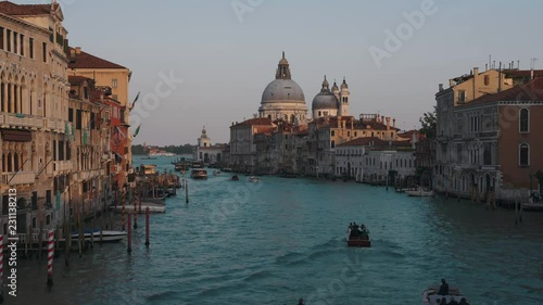 4K time lapse of beautiful view of gondolas, water taxis, and vaporetto passing by a beautiful cathedral on the Grand Canal in Venice, Italy, Europe