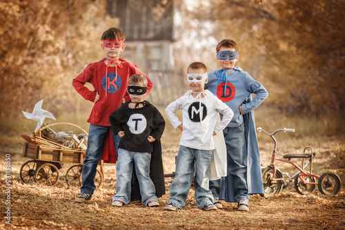 Canvas Print Four boys play a superhero in the playground
