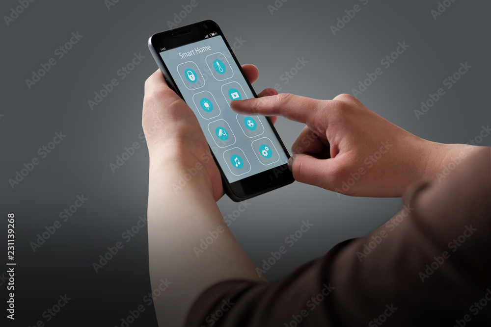 custom made wallpaper toronto digitalCloseup of woman's hands with black smartphone and Smart home application icons interface design. House automation concept.