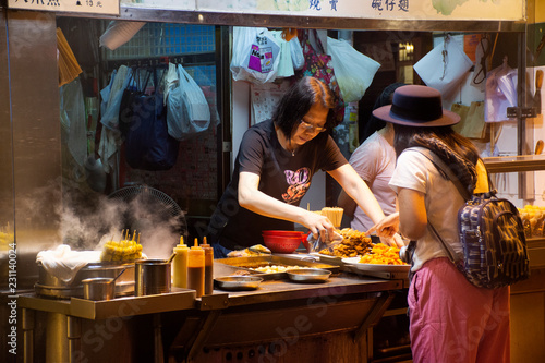 Travelers thai woman select and buy cuisine from Street Food in Hong Kong, China