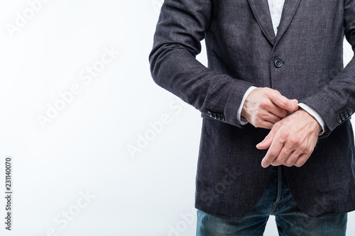 business man adjusting sleeve. success and confidence concept. white background.
