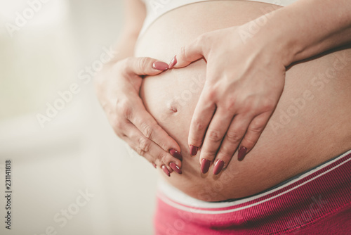 Wallpaper Mural Pregnant belly with hands in heart shape Torontodigital.ca