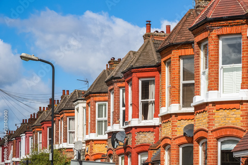 A row of typical red brick British terraced houses in London