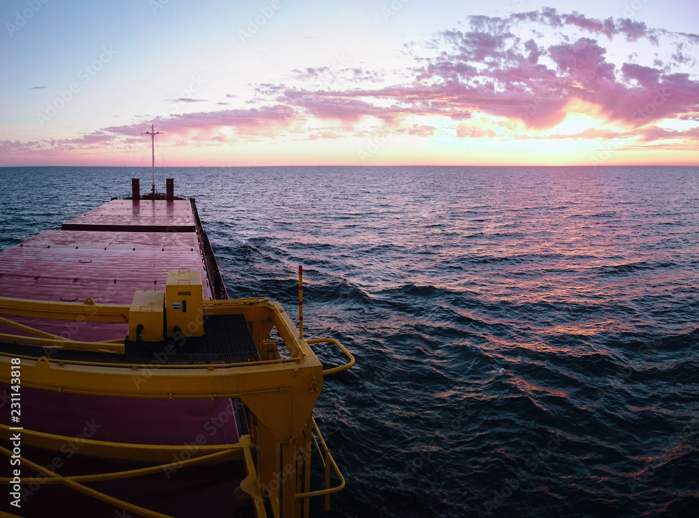 Obraz premium Sunset view from a cargo vessel.