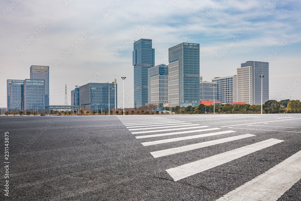 Panoramic skyline and modern business office buildings with empty road,empty concrete square floor Panoramic skyline and modern business office buildings with empty road,empty concrete square floor