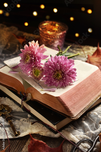 vintage style still life with opened book and flowers