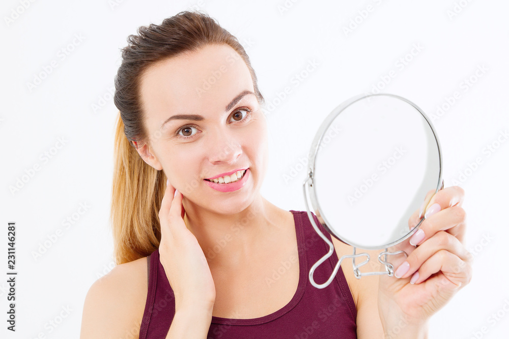 Young caucasian woman looking wrinkles on face in mirror isolated on white background. Skin care, anti aging and makeup concept. Copy space Young caucasian woman looking wrinkles on face in mirror isolated on white background. Skin care, anti aging and makeup concept. Copy space