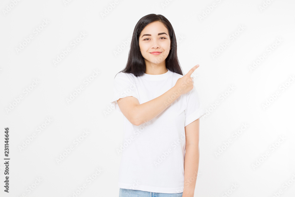 Portrait of smiling young asian woman wearing summer t shirt pointing at copy space by finger isolated on white template and blank background. Portrait of smiling young asian woman wearing summer t shirt pointing at copy space by finger isolated on white template and blank background.