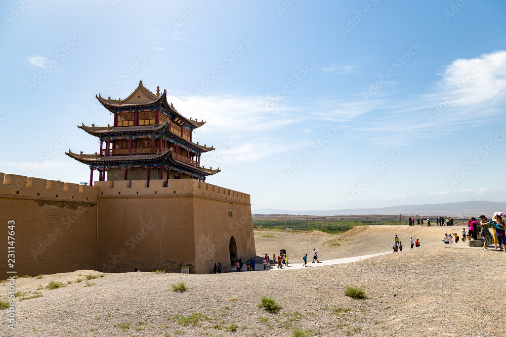 Tourists outside of the gate facing the Gobi desert of Jiayuguan Fort ...