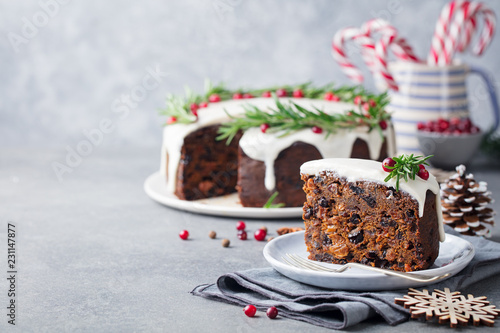 Christmas fruit cake, pudding on white plate. Traditional New Year dessert. Copy space. photo