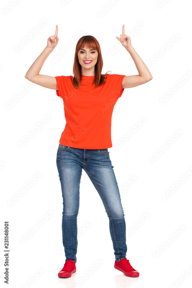 Young Woman Is Pointing Above Her Head And Smiling Young Woman Is Pointing Above Her Head And Smiling