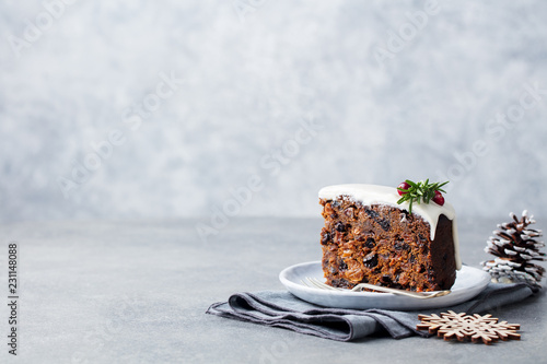 Bild auf Leinwand Christmas fruit cake, pudding on white plate. Copy space.