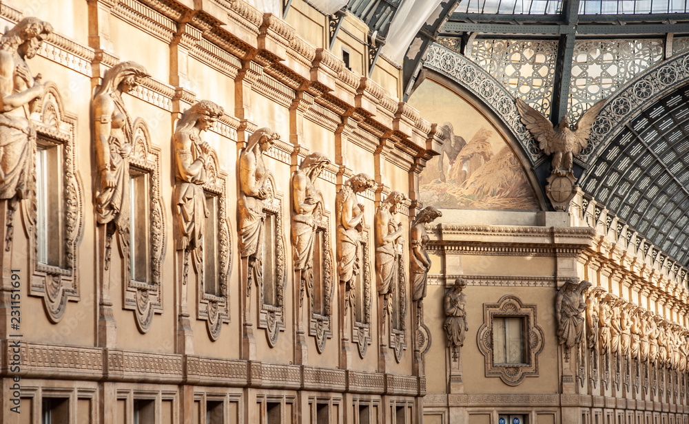 Obraz premium The statues of Galleria Vittorio Emanuele II in Milan, Italy. Built in 1875 this gallery is one of the most popular landmarks and luxury shopping areas in the city