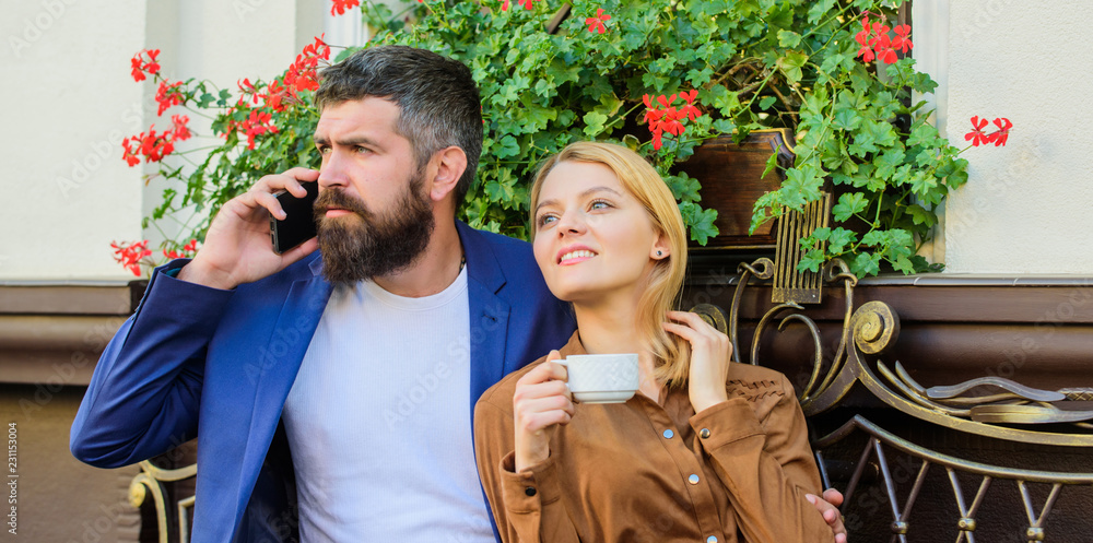 Fototapeta premium Dating businessman. Couple in love sit cafe terrace enjoy coffee while man speak phone. Girl dating with businessman. Things know before you date entrepreneur businessman. Find and date businessman