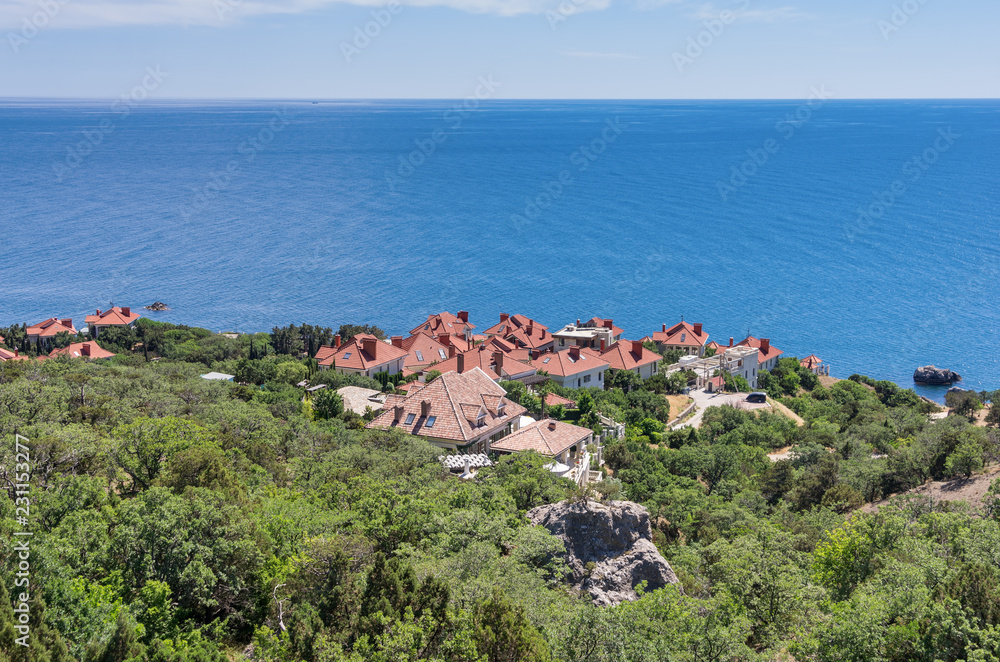 Cottage village with red roofs on the background of the sea. Russia. 12.06.2018: Quiet, peaceful place on the southern coast of Crimea