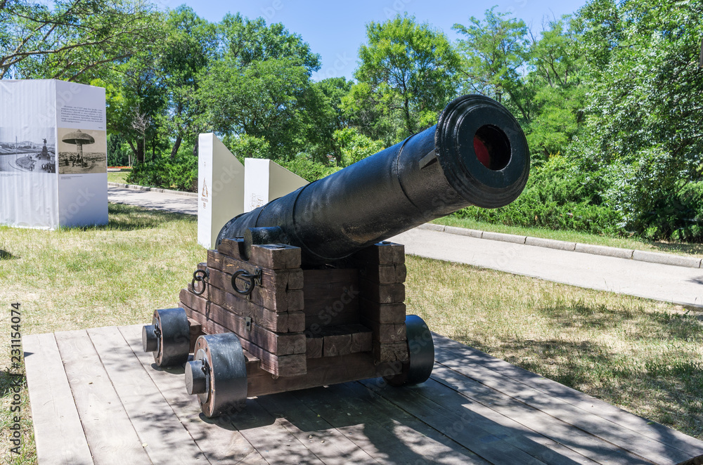 Old muzzle-loading gun. Russia, the Republic of Crimea, the city of Sevastopol. 06/12/2018: Old cast-iron ship cannon in the park on Historical Boulevard