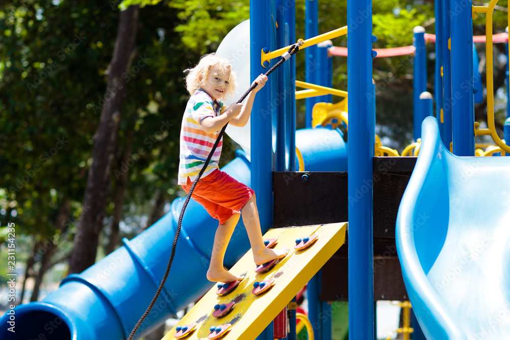 Kids on playground. Children play in summer park.