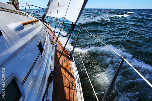 Sail boat gliding in open sea