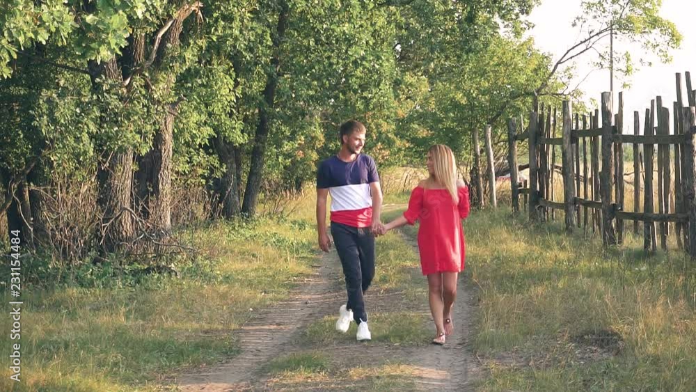young couple in love outside the city in nature at sunset young couple in love outside the city in nature at sunset
