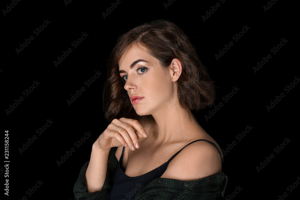 Naklejka premium Portrait of beautiful young woman on dark background