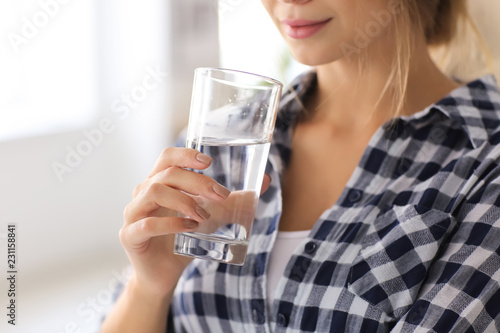 Beautiful young woman drink...