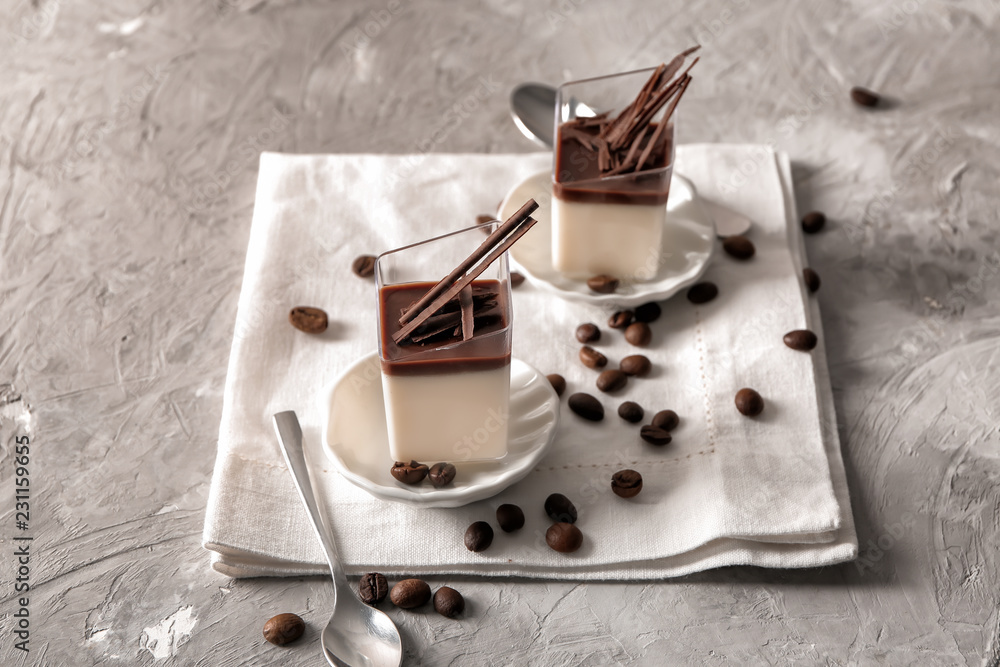 Glasses with tasty chocolate panna cotta on grey table Glasses with tasty chocolate panna cotta on grey table