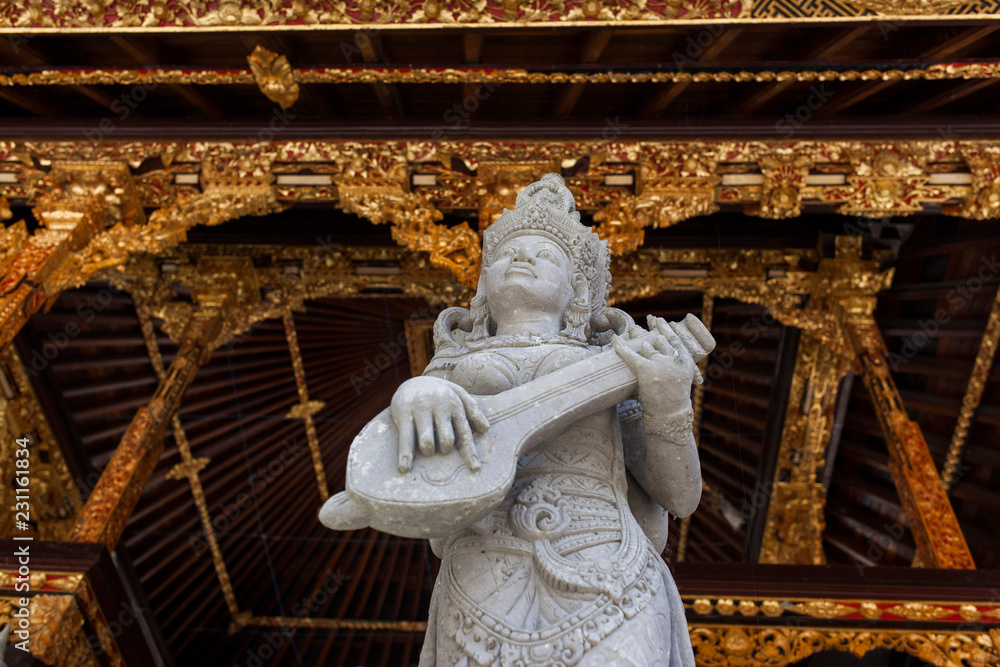 escultura tocando instrumento musical en un templo de bali