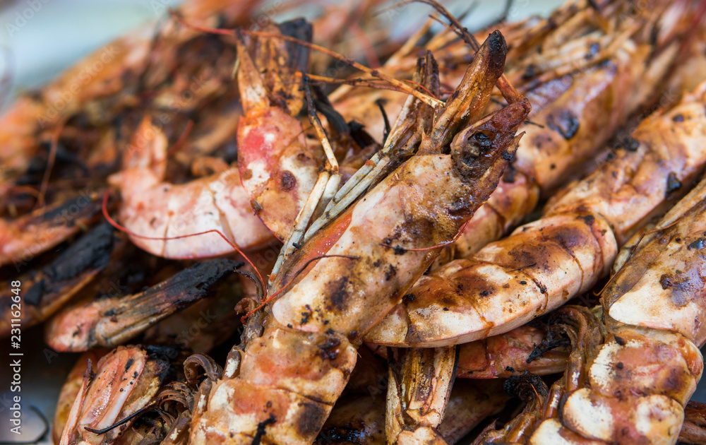 Appetizing grilled royal shrimp. Seafood grill on the stove, on the street food market. Appetizing grilled royal shrimp. Seafood grill on the stove, on the street food market.