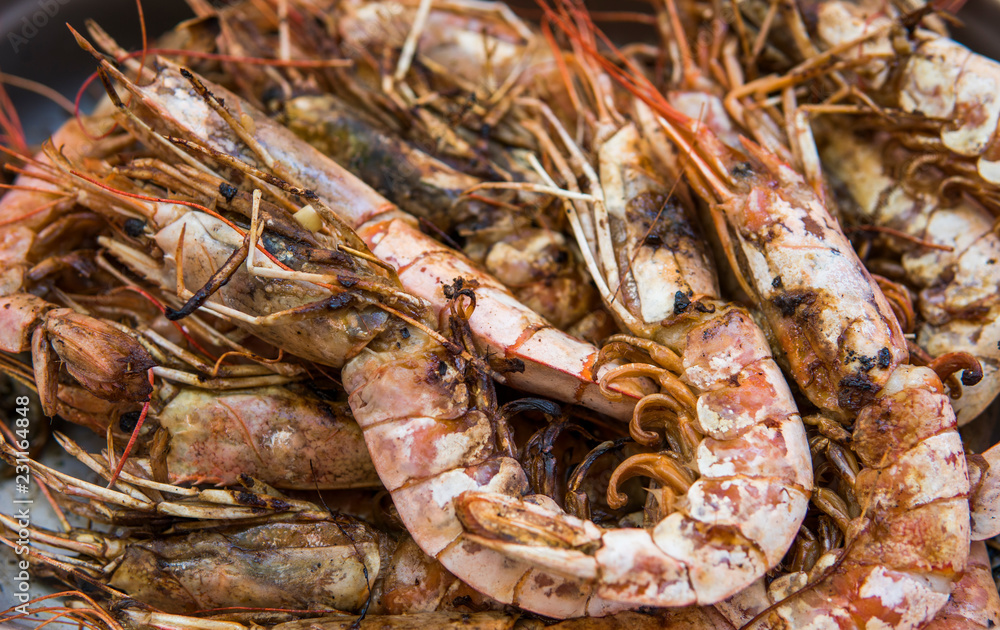 Appetizing grilled royal shrimp. Seafood grill on the stove, on the street food market. Appetizing grilled royal shrimp. Seafood grill on the stove, on the street food market.