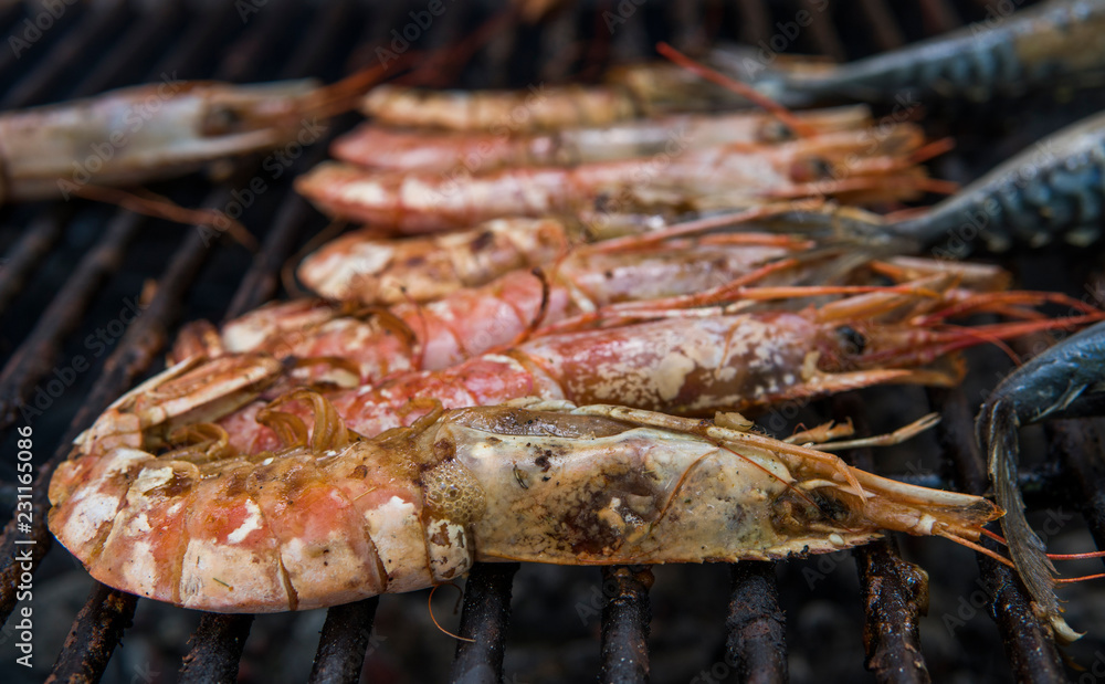 Cooking fresh king's shrimp on a grill on a foodfest.