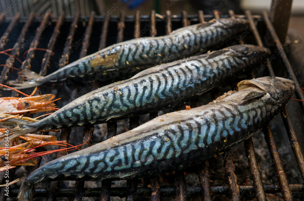 Appetizing mackerel grilled on a fest food. Steet food.