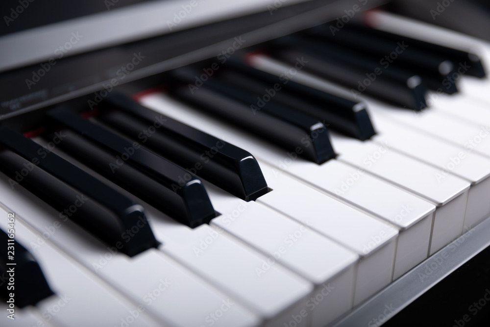 Grand piano keyboard with glossy black and white keys as a music, Select focus and soft focus. Grand piano keyboard with glossy black and white keys as a music, Select focus and soft focus.