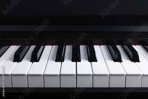 Grand piano keyboard with glossy black and white keys as a music, Select focus and soft focus.