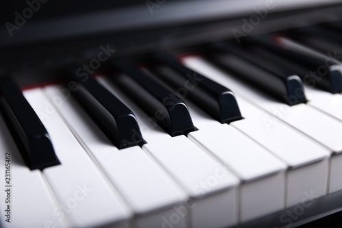 Grand piano keyboard with glossy black and white keys as a music, Select focus and soft focus.