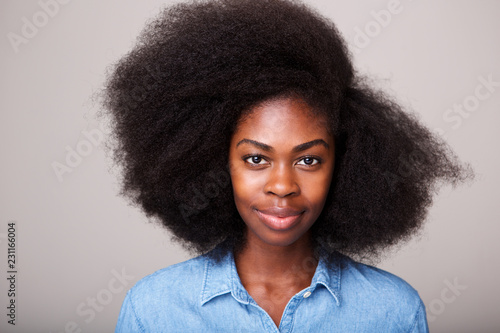 Close up portrait of beautiful young black woman with afro hair staring photo