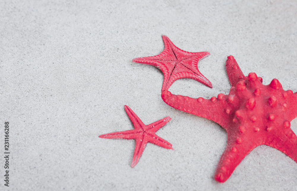 Red sea stars on the sand. Summer beach background in Thailand Red sea stars on the sand. Summer beach background in Thailand