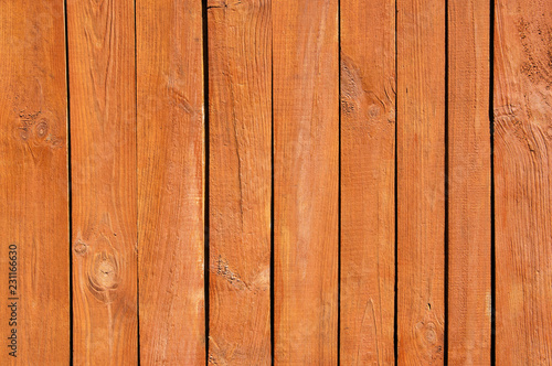 Close up of brown painted wooden fence panels.