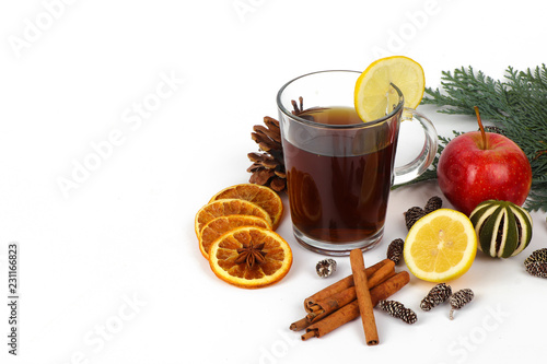 christmas background - christmas tea or mulled wine - cup of red tea and orange - isolated on white background