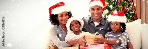 Composite image of smiling family sharing christmas presents