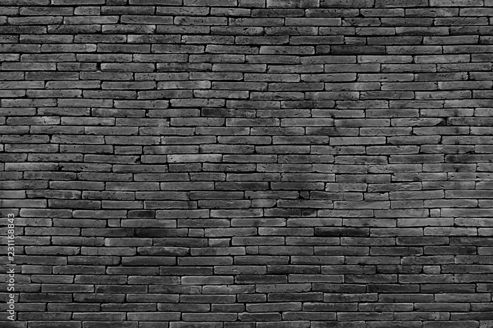 Dark gray brick wall as a background or texture